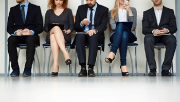 A team of business individuals sitting on chairs